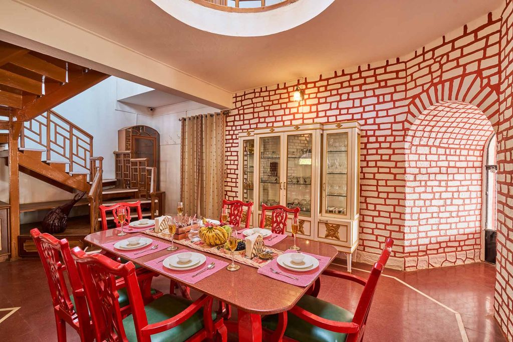 Skylit dining hall with red carved chairs